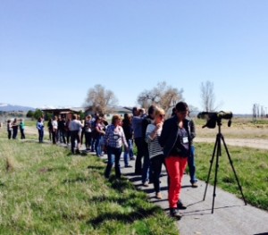 A group sees a baby bald eagle through the scope.