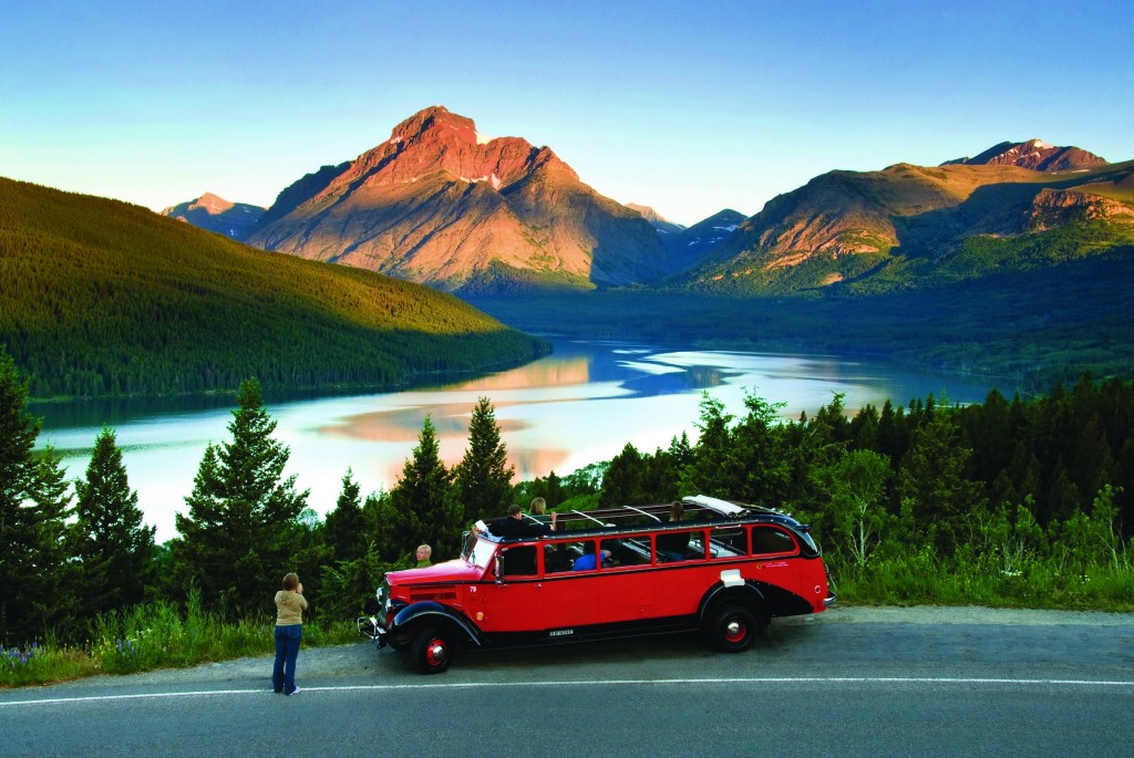 The view of Two Medicine from Looking Glass Highway and a red bus tour. 