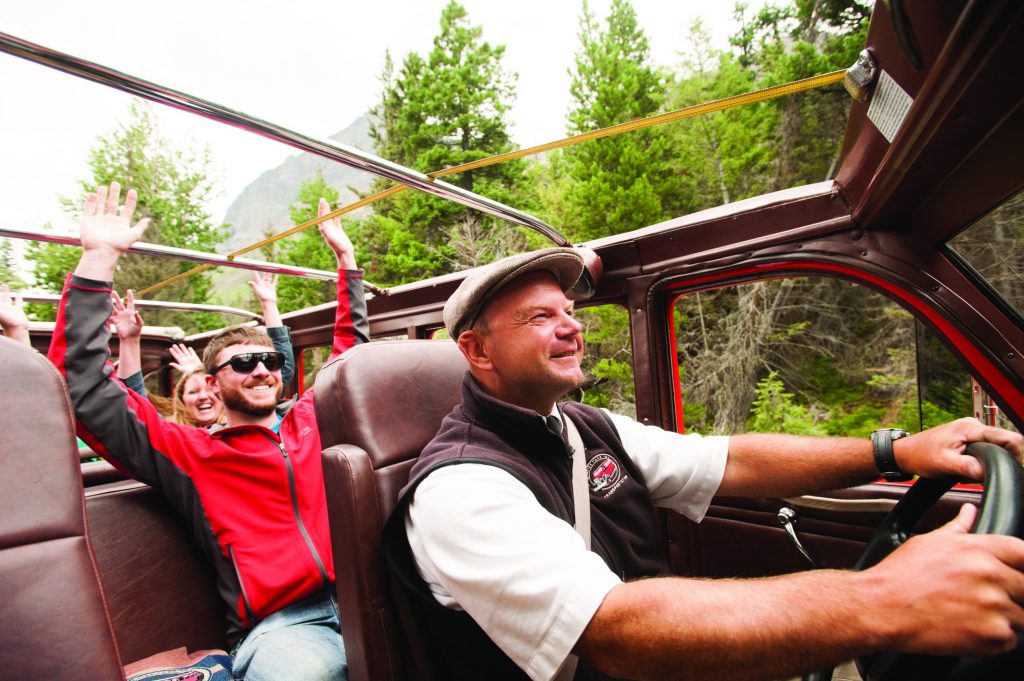 A red bus tour on the Going-to-the-Sun Road in Glacier National Park.