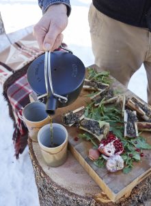 The chef prepares an outdoor lunch. 